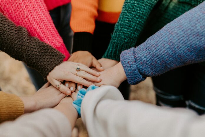 Girlfriends' hands piled together