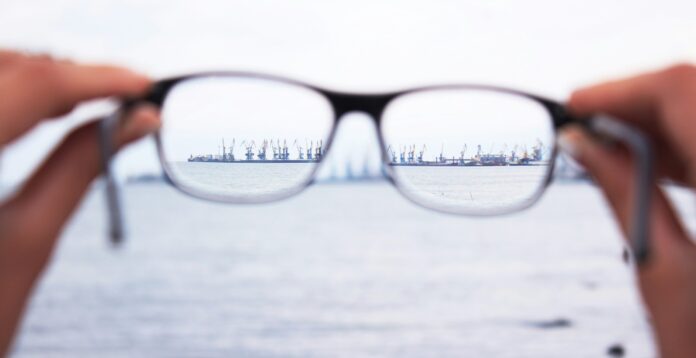 A pair of glasses bringing a distant image into focus