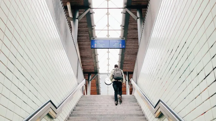 Person climbing the stairs of a subway station