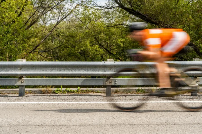 Person in motion riding a bicycle on the road