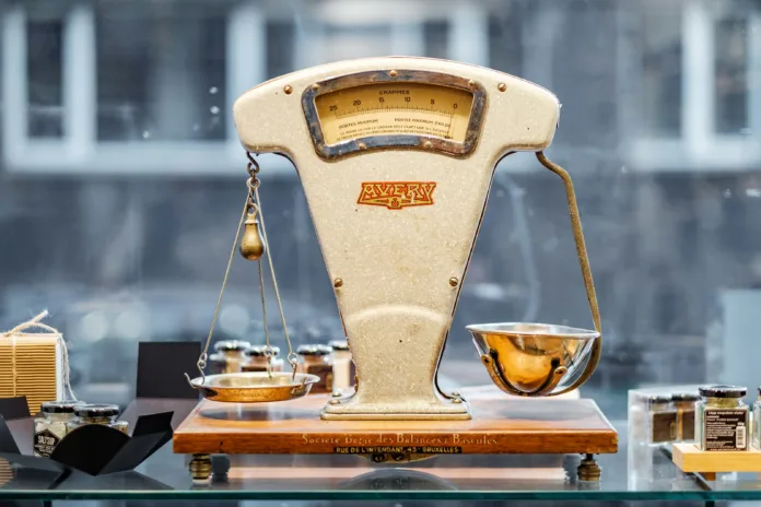 Scales with one side weighed down over the other