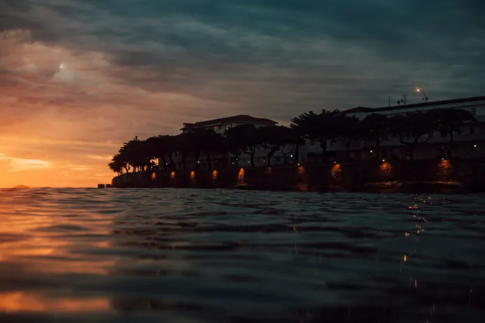 Silhouette of a building near a body of water